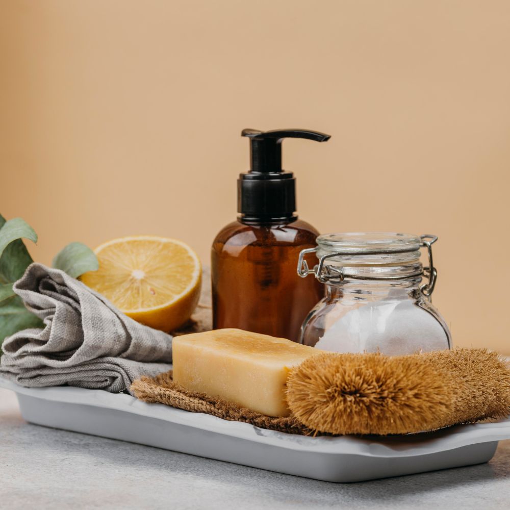 Natural soap lemon pump bottle and brush on white tray