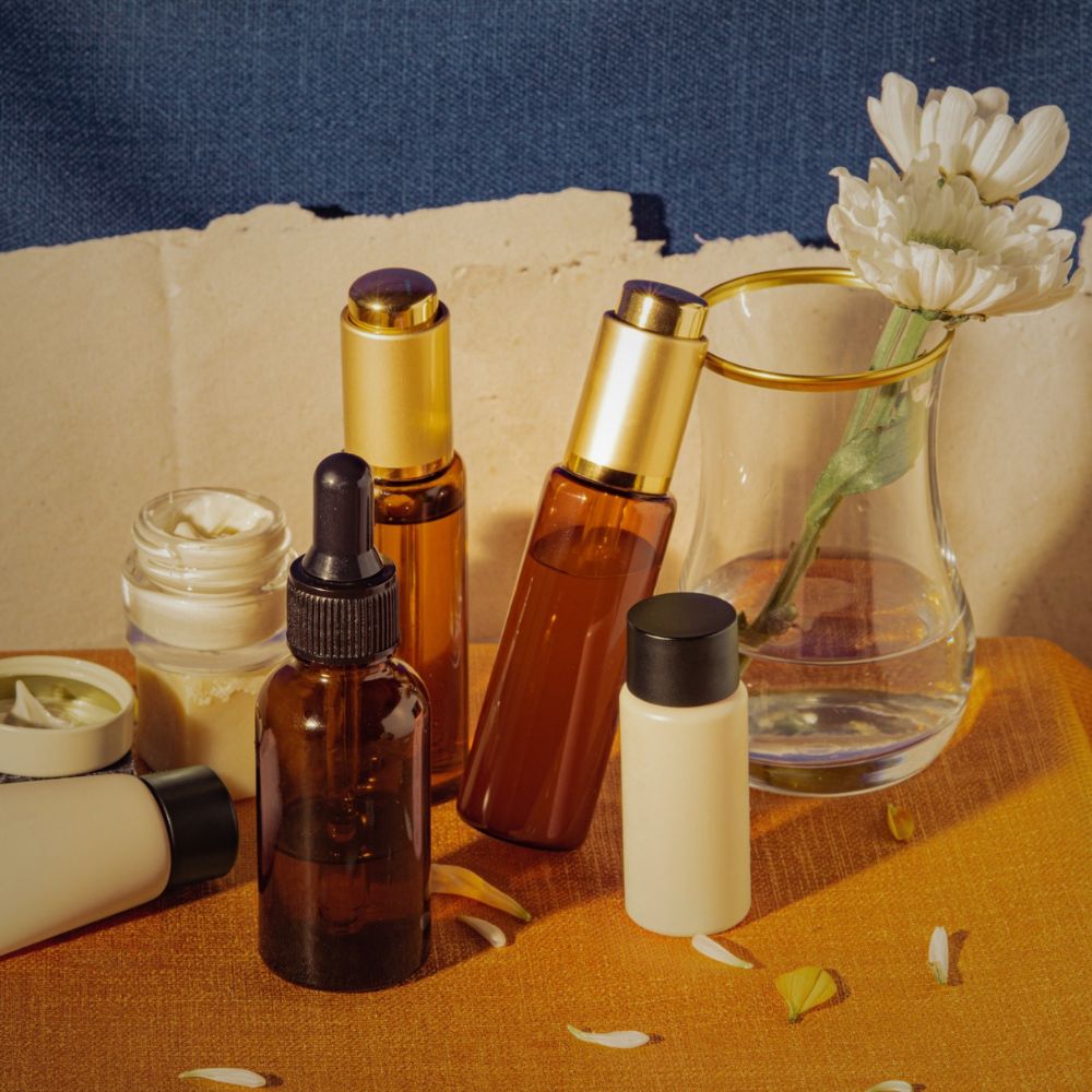 Amber glass skincare serums and oils with white flower